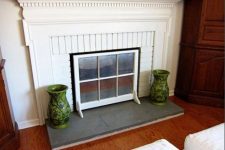 06 a non-working fireplace cover made of an old window frame is a stylish and very easy idea to go for