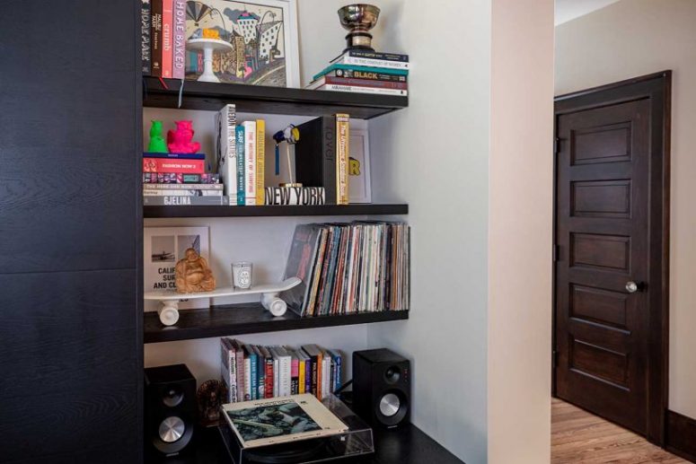 There are built-in open shelves and a closed storage unit here