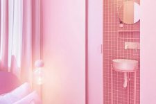 08 The bathroom is clad with pink tiles, and you may see a small round mirror and a sink on a stand