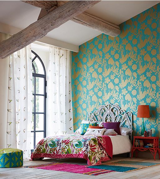 super bright turquoise and gold paetterned wallpaper for accenting a bold boho bedroom