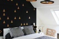 11 a gorgeous black and gold geometric pattern accent wall plus black and brass pendant lamps that echo with it