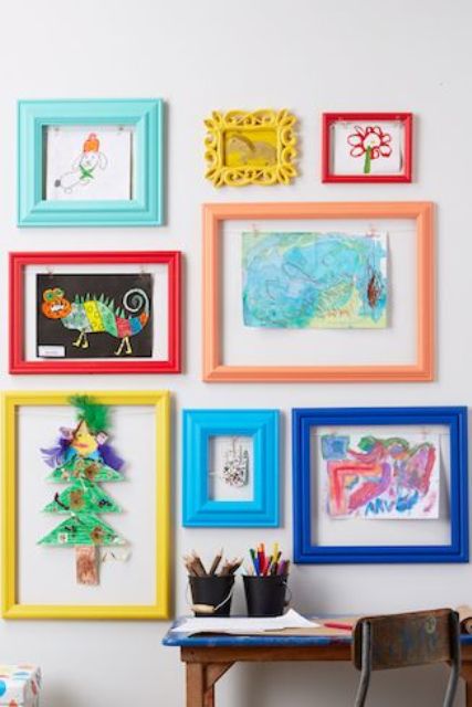 a colorful gallery wall with kids' artworks placed into colorful frames is a bold decor idea to rock