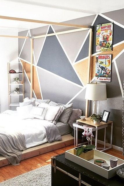 a modern bedroom with a geometric print accent wall, simple furniture and bold posters is a bold idea