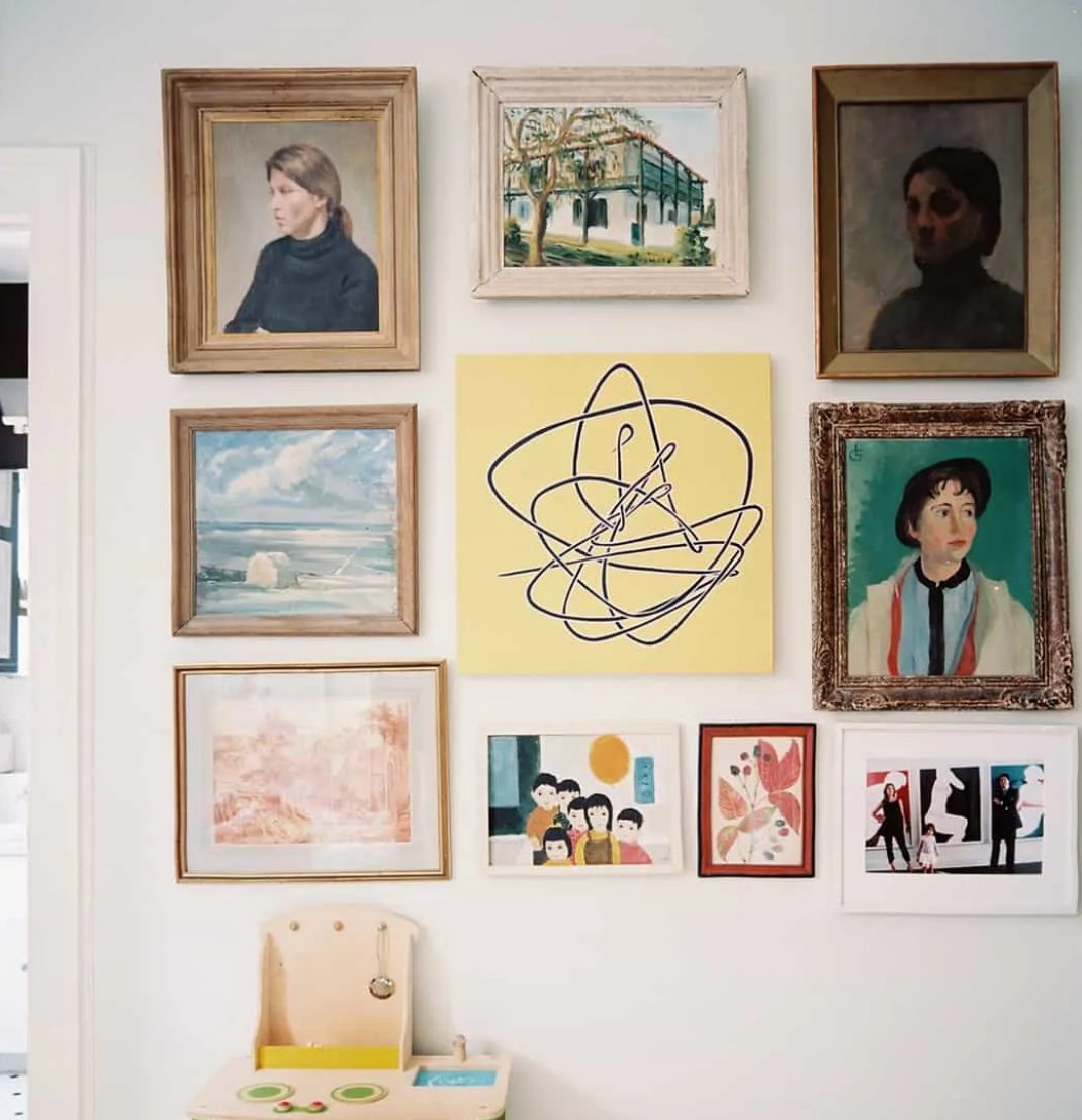 a gallery wall where usual and bold artworks are paired with kids' works and look super cool together
