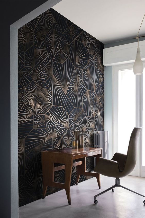 an exquisite modern home office nook with a bold geometric print statement wall, catchy furniture and candle lanterns