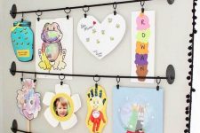 14 a bold kids’ artwork display with railings is a stylish and cool idea and you may add more and more works there