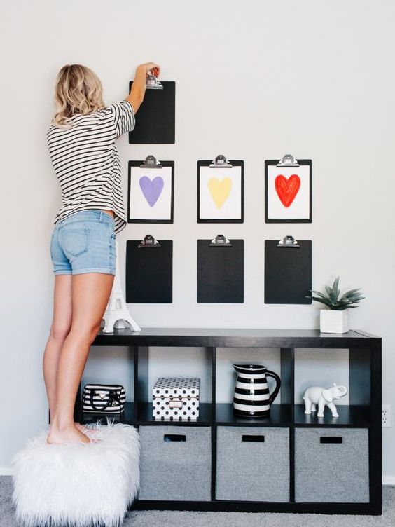 a kids' artwork gallery wall organized like that is a very creative and bold idea to go for