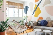 20 a modern and airy living room with a bold terrazzo accent wall that brings a fun and colorful touch to the space
