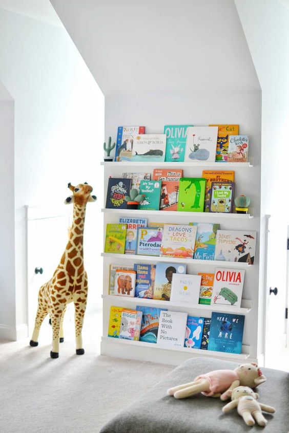 a comfy space for reading - ledges with colorful kid books and a soft seat with toys