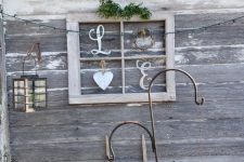25 a pretty and easy rustic artwork made of an old window frame, some wooden letters, a wreath and a heart plus greenery can be used indoors and outdoors