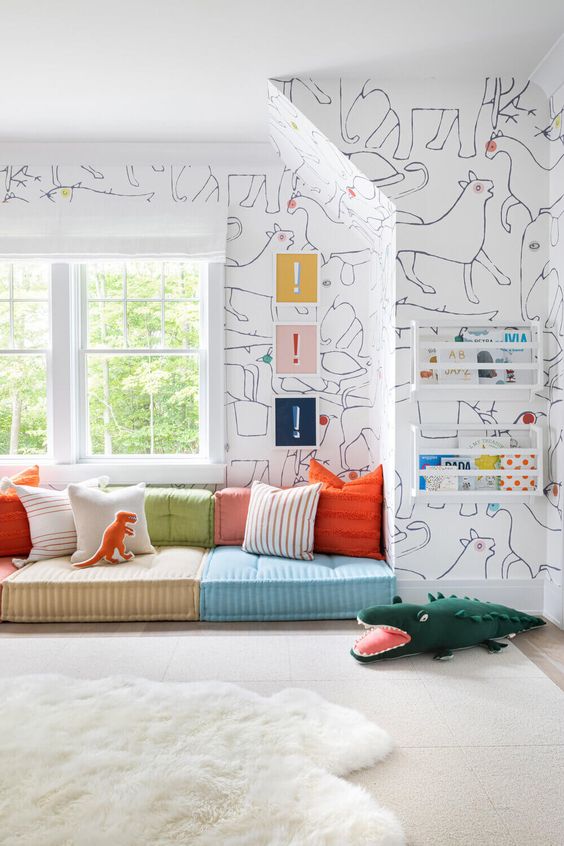 a stylish modern reading nook with colorful seats and pillows, bold art and books in shelves