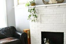 25 a white faux brick fireplace with a cozy fuzzy dog bed inside it is a great way to use a non-working fireplace