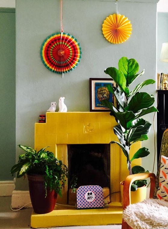 - تصآميم مدفأة ملونة انيقة .. ! A-bold-yellow-fireplace-clad-with-tiles-contrasts-the-soft-and-soothing-mint-color-on-the-wall