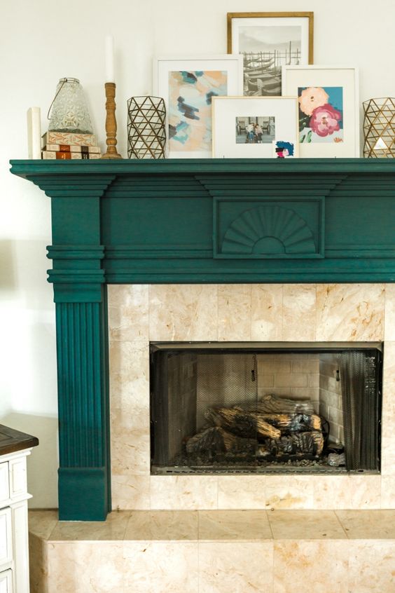 a fireplace clad with neutral beige tiles and surrounded with an emerald mantel is a cool addition to a living room