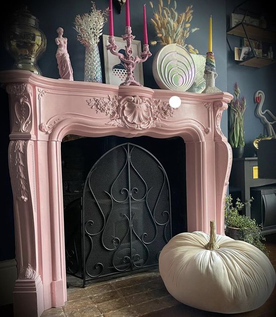 a non-working fireplace with a pink vintage mantel and some bright decor on it is a gorgeous idea for a refined living room