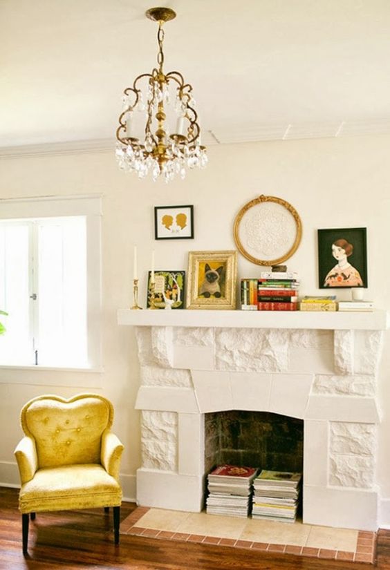 a non-working fireplace with books inside, with books on the mantel, some artwork and candles is lovely