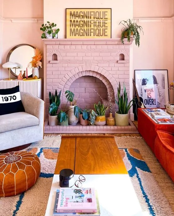 - تصآميم مدفأة ملونة انيقة .. ! A-pink-brick-fireplace-with-potted-plants-instead-of-fire-is-a-cool-and-fresh-decor-idea-for-a-boho-space