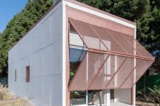 01 This small prefab home features a large folding screen that is a layer of protection to the house
