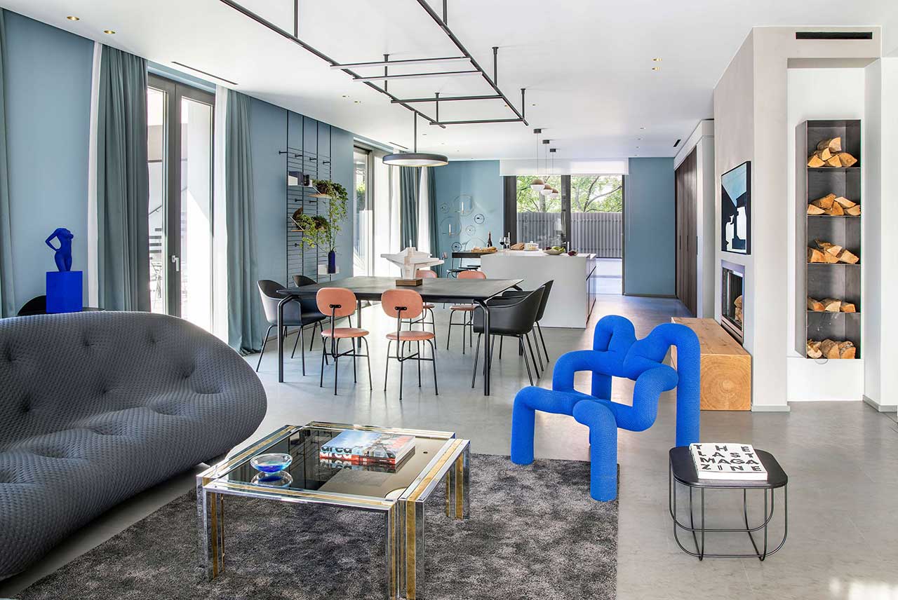 This unique home is done in a color palette of grey and blues, with bold electric blue touches that will make your jaw drop