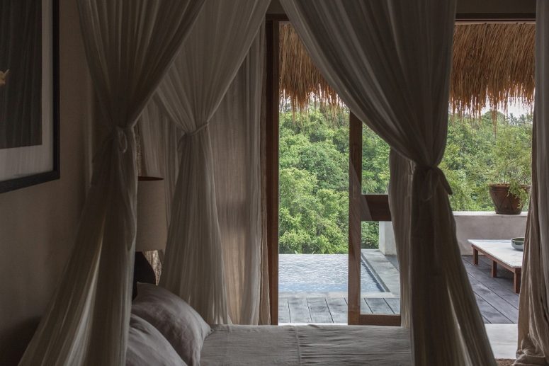 The bedroom is done in pure neutrals, with a comfy bed and gorgeous views