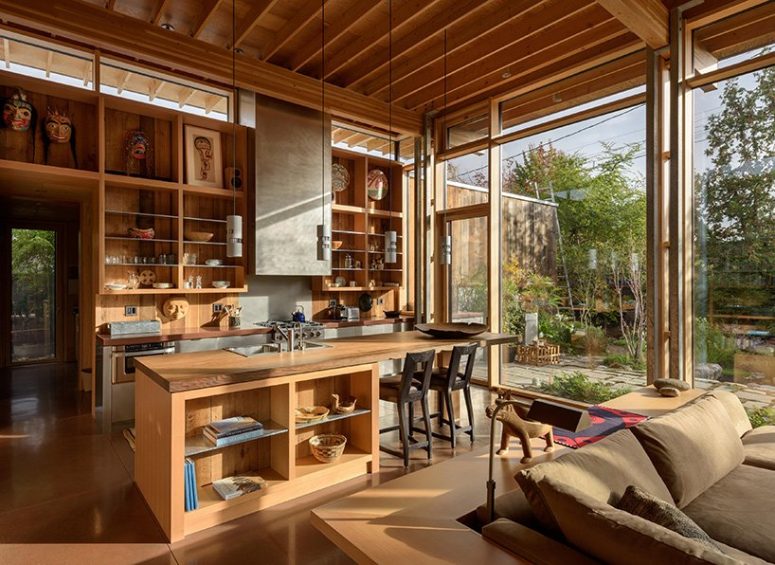 The main layout comprises a kitchen, a living and dining space and is filled with natural light coming through glazed walls The main layout comprises a kitchen, a living and dining space and is filled with natural light coming through glazed walls