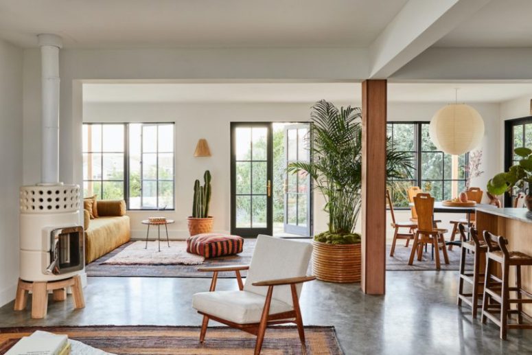 gorgeous open layout with plants The main layout is an open space filled with natural light, there's a kitchen, dining room and two sitting spaces here