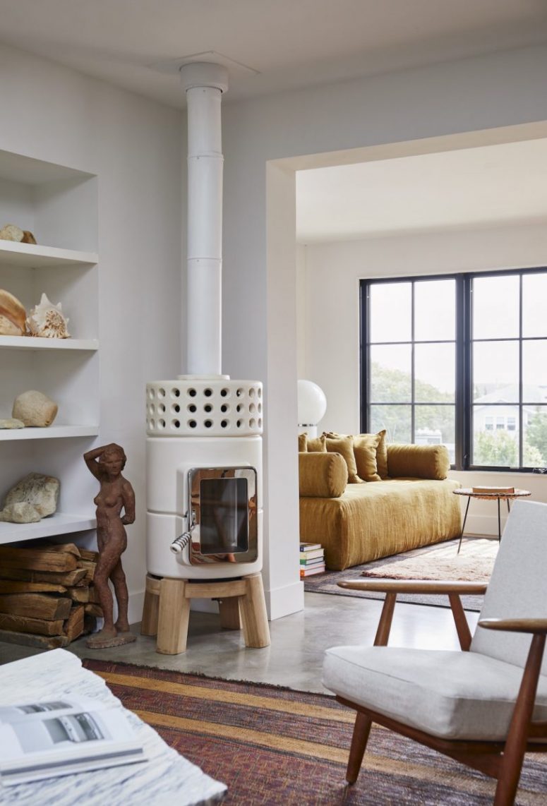 One sitting space is located byt the window, another is next to the kitchen and is lit by a hearth and a skylight One sitting space is located byt the window, another is next to the kitchen and is lit by a hearth and a skylight