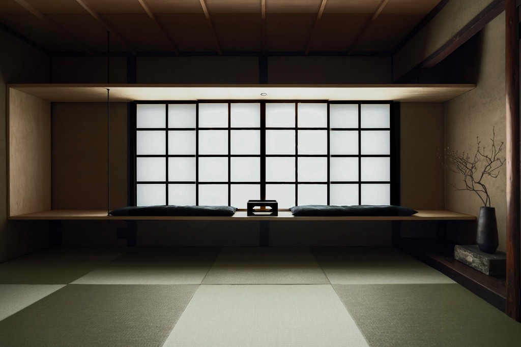 This is a yoga space with very minimalist furniture and traditional Japanese windows