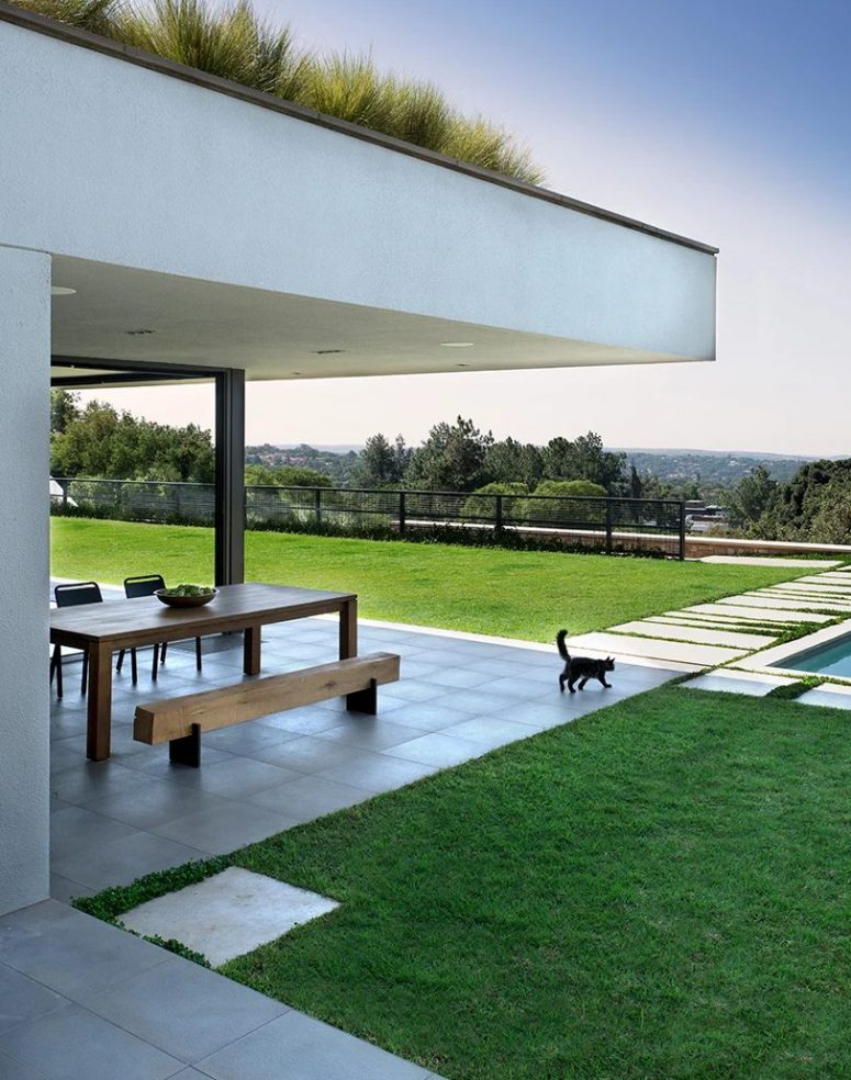 A cantilever allows an overhead roof garden to float and dining here anytime even if it's raining