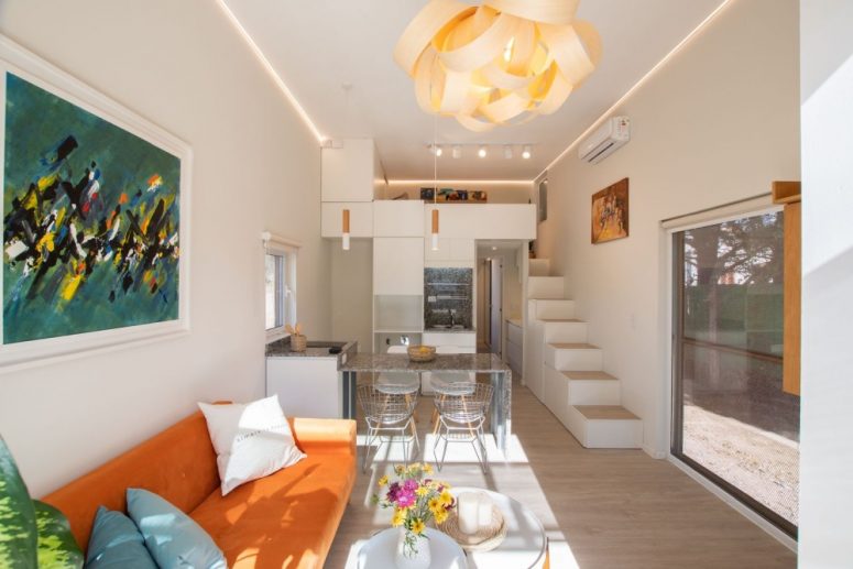 The living area is oriented towards a large window which is intended to serve as a focal point