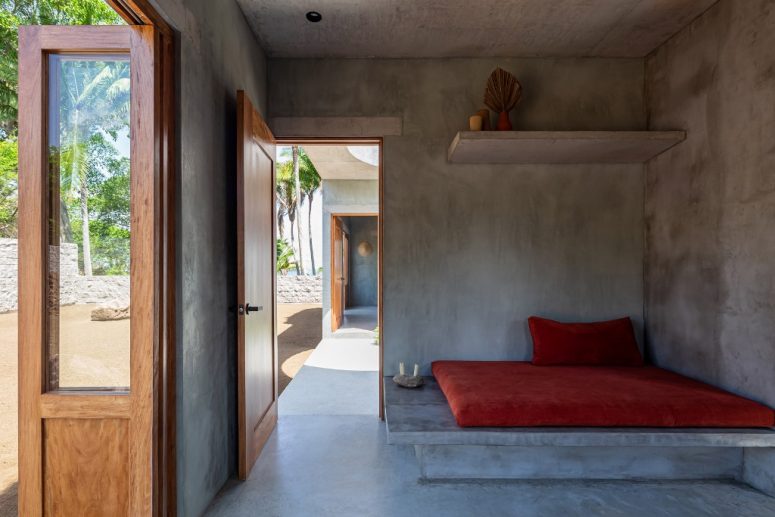 A plinth forms a seat for the lounge, there are shelves above it and it's opened to outdoors