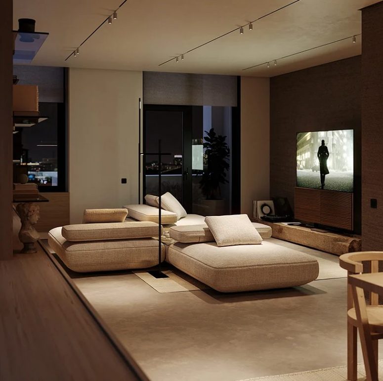 The living room is all-neutral, with a cool sectional, a TV and some more shelves