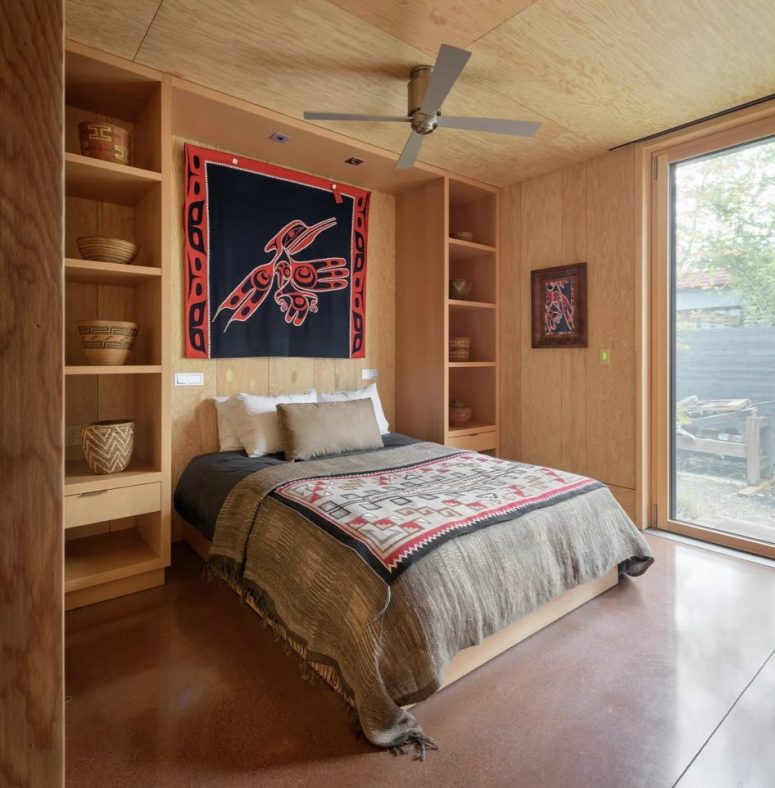 The second bedroom is done in the same style as the first one, with open shelving and bright boho textiles The second bedroom is done in the same style as the first one, with open shelving and bright boho textiles