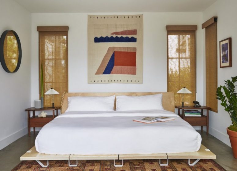 The master bedroom is done with bold touches, comfortable mid century modern furniture and burlap shades The master bedroom is done with bold touches, comfortable mid-century modern furniture and burlap shades