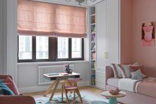 10 The kid’s room is done with blush and pink furniture, blush curtains, a geometric rug and catchy tables