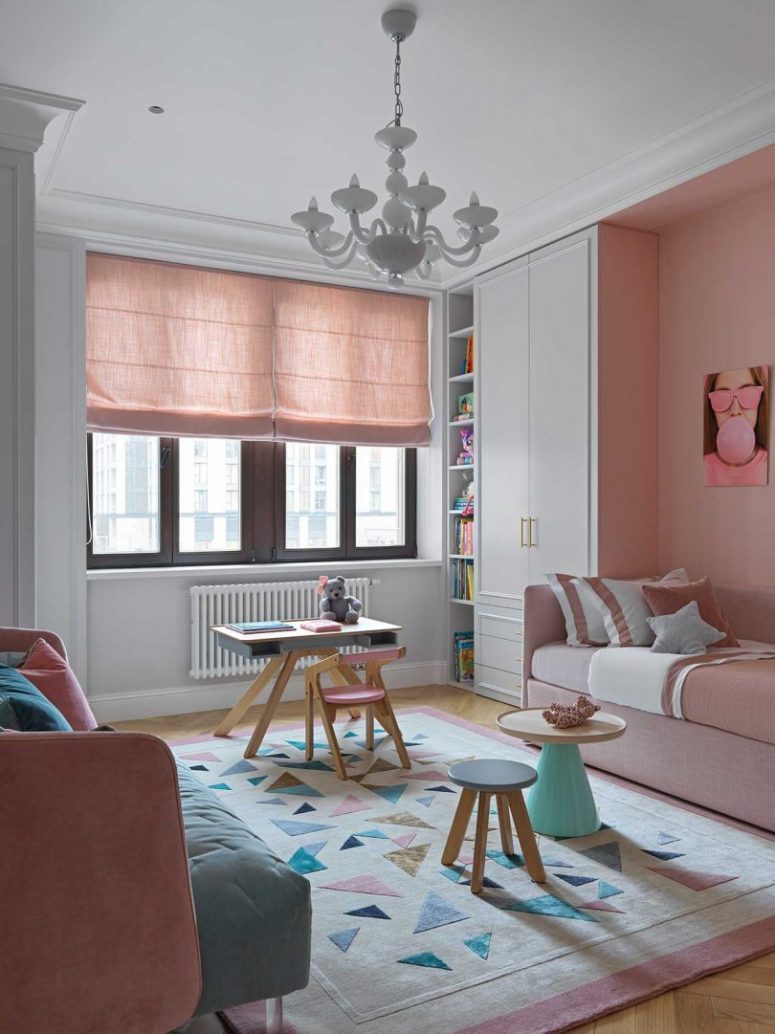 The kid's room is done with blush and pink furniture, blush curtains, a geometric rug and catchy tables