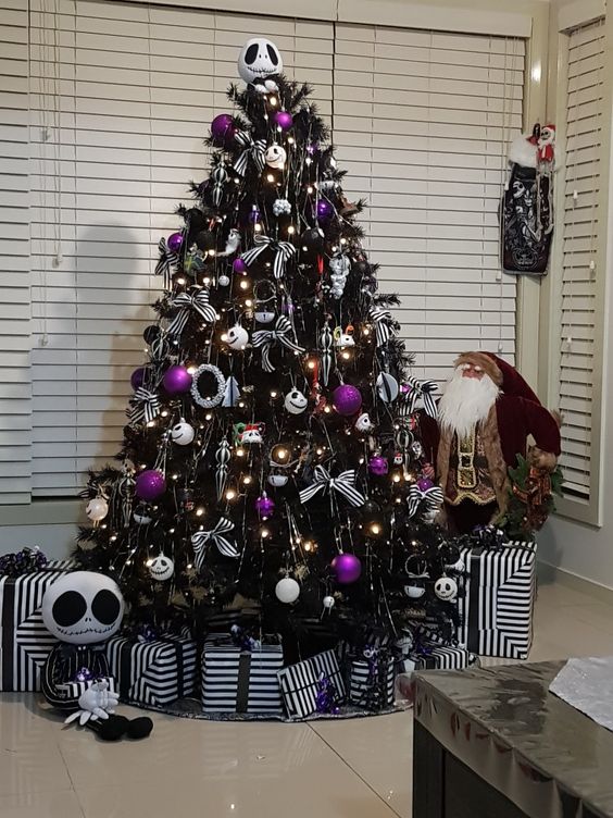 a black Halloween tree decorated with lights, Jack Skellington ornaments, purple ones and some striped bows