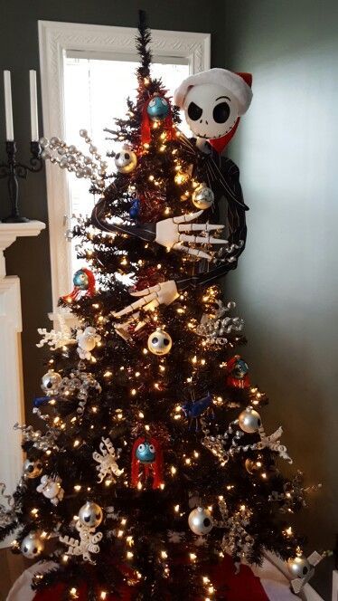 a black Halloween tree decorated with lights, skulls, snowflakes and Jack Skellington embracing it for tim Burton fans
