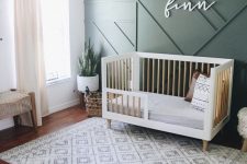 a chic contemporary nursery with a green paneled wall, mid-century modern furniture, neutral textiles and potted greenery