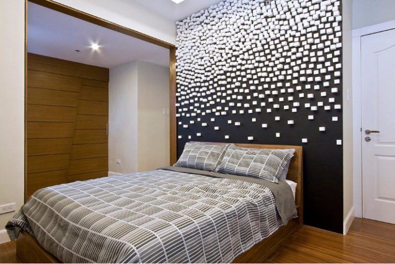 a contemporary bedroom with a black wall and a geometric 3D pattern on it for a galatic effect is wow