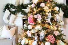 a glam Christmas tree decorated with blush and pink faux blooms, white snowballs and deer plus some lights