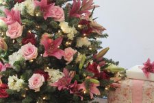 a lovely Christmas tree decorated with lights, white, pink and burgundy blooms is a very glam and cool option