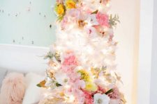 a lovely white Christmas tree with white, pink, yellow blooms, pale greenery and lights is an ethereal and chic idea to rock