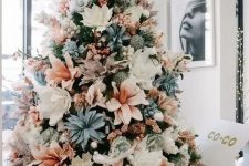 a pastel Christmas tree with white, blush, pale blue fabruc blooms and some pink garlands is a unique idea to go for