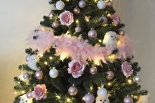 a pretty Christmas tree with white and blush ornaments, white owls, pink feather garlands and lights is very chic and bold
