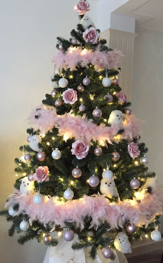a pretty Christmas tree with white and blush ornaments, white owls, pink feather garlands and lights is very chic and bold