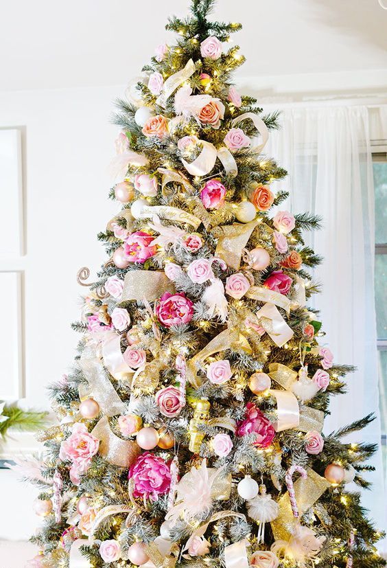 a romantic Christmas tree decorated with gold mesh ribbons, lights, gold and silver ornaments, pink, blush and hot pink blooms