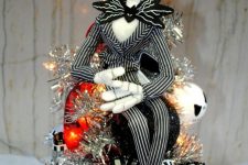 a silver lit up Nightmare Before Christmas tree with Jack ornaments and striped ribbons is a lovely and bold idea to rock