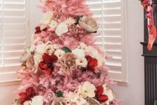 a small pink Christmas tree decorated with white, neutral, red and pink blooms – faux and natural ones for a glam feel