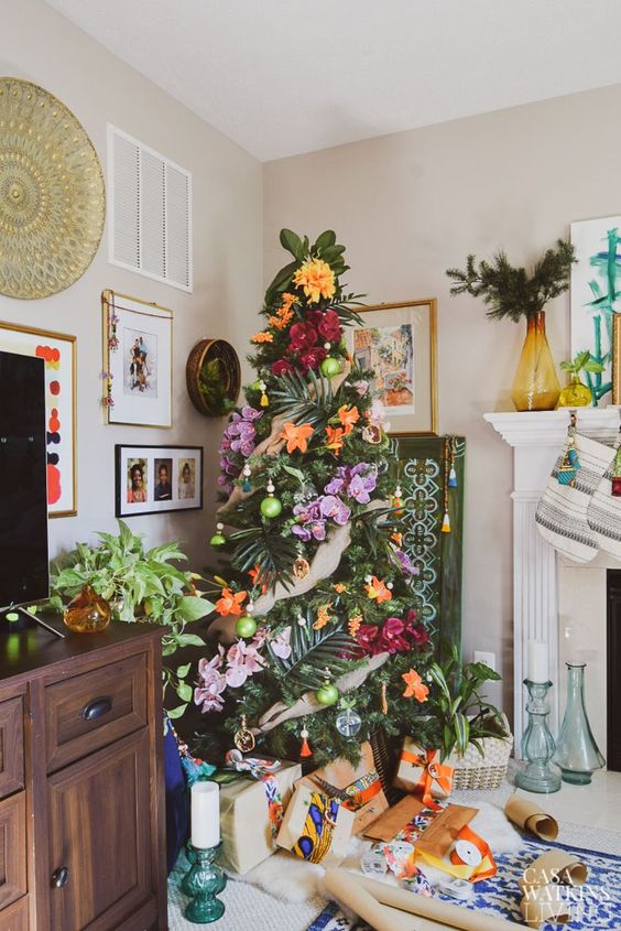 a tropical Christmas tree decorated with tropical leaves and super bold blooms for those who love tropics but can't go there now